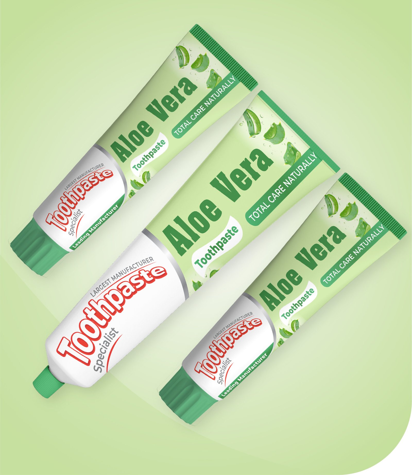 Tubes of aloe vera toothpaste are displayed against a light green background. The tubes feature aloe vera leaf graphics and text indicating Total Care Naturally. They have green caps and the label emphasizes natural care.