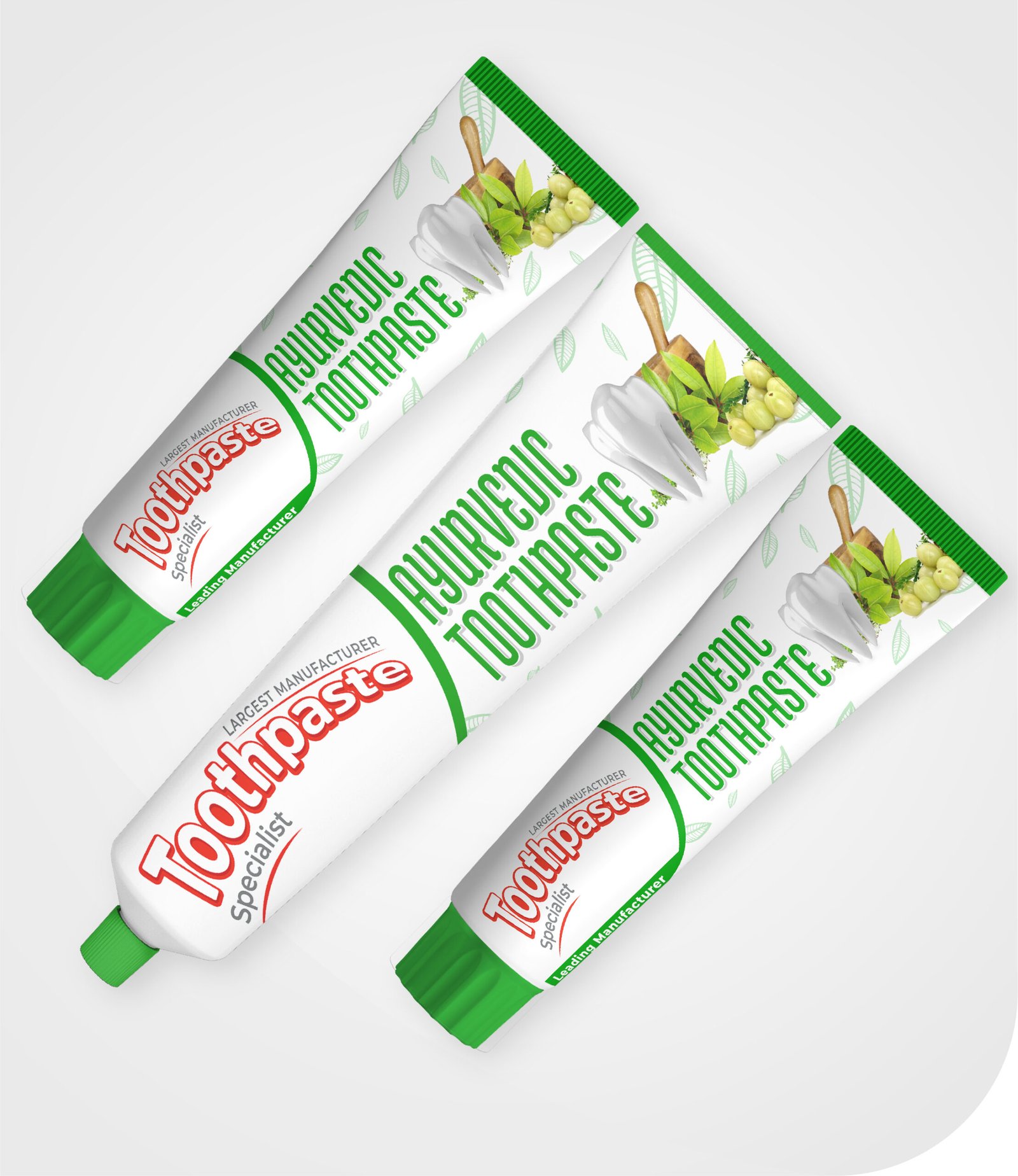 Three tubes of Ayurvedic toothpaste are arranged diagonally. The packaging features green caps and images of herbs and leaves with Ayurvedic Toothpaste branding.